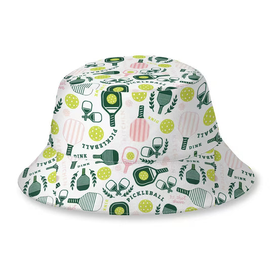 A white bucket hat featuring a colorful pickleball-themed pattern with green paddles, yellow balls, pink striped rackets, and green leaves, shown on a plain white background.