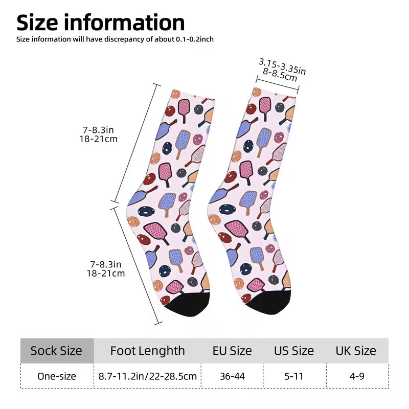 Sock size information graphic showing a pair of patterned socks with dimension annotations and a size conversion table. The socks have a light pink background with a multicolor ice cream cone and donut print, black toes, and black heels.