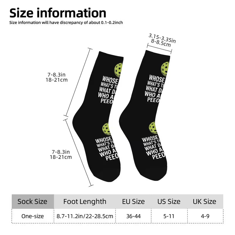 Size information graphic for black crew socks with white text reading 'WHOSE WHAT I DO WHO A PEECO' and small green circular graphics, showing sock length measurements and a size table at the bottom.