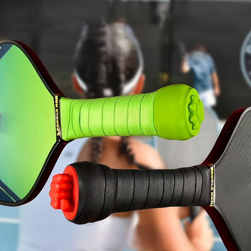 Two pickleball paddles shown close-up with blurred people in a court in the background. One paddle has a bright lime green frame and handle, and the other has a black handle with a red end cap.