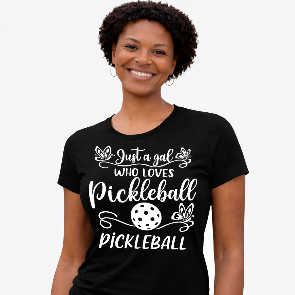 Woman wearing a black t-shirt with pickleball-themed text and graphics on a white background