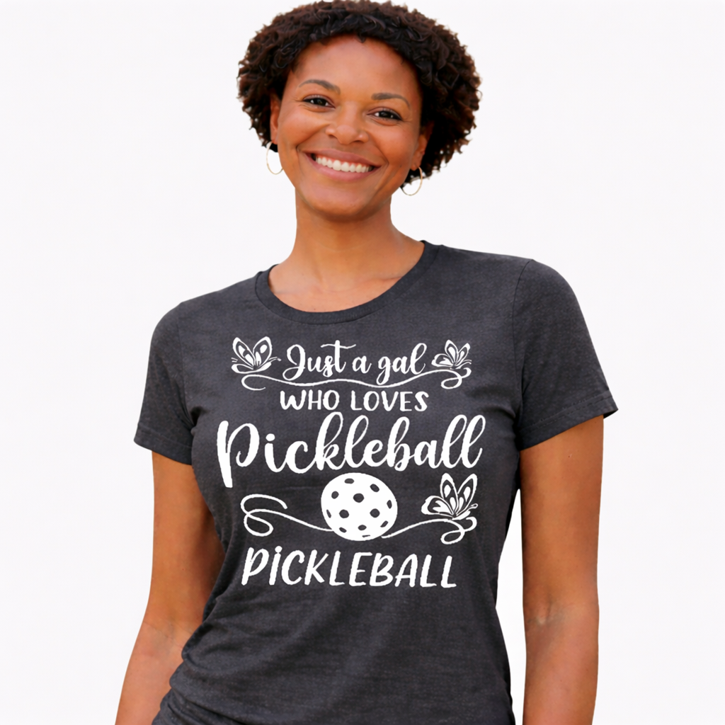 Woman wearing a dark gray t-shirt with pickleball-themed text and graphics on a white background
