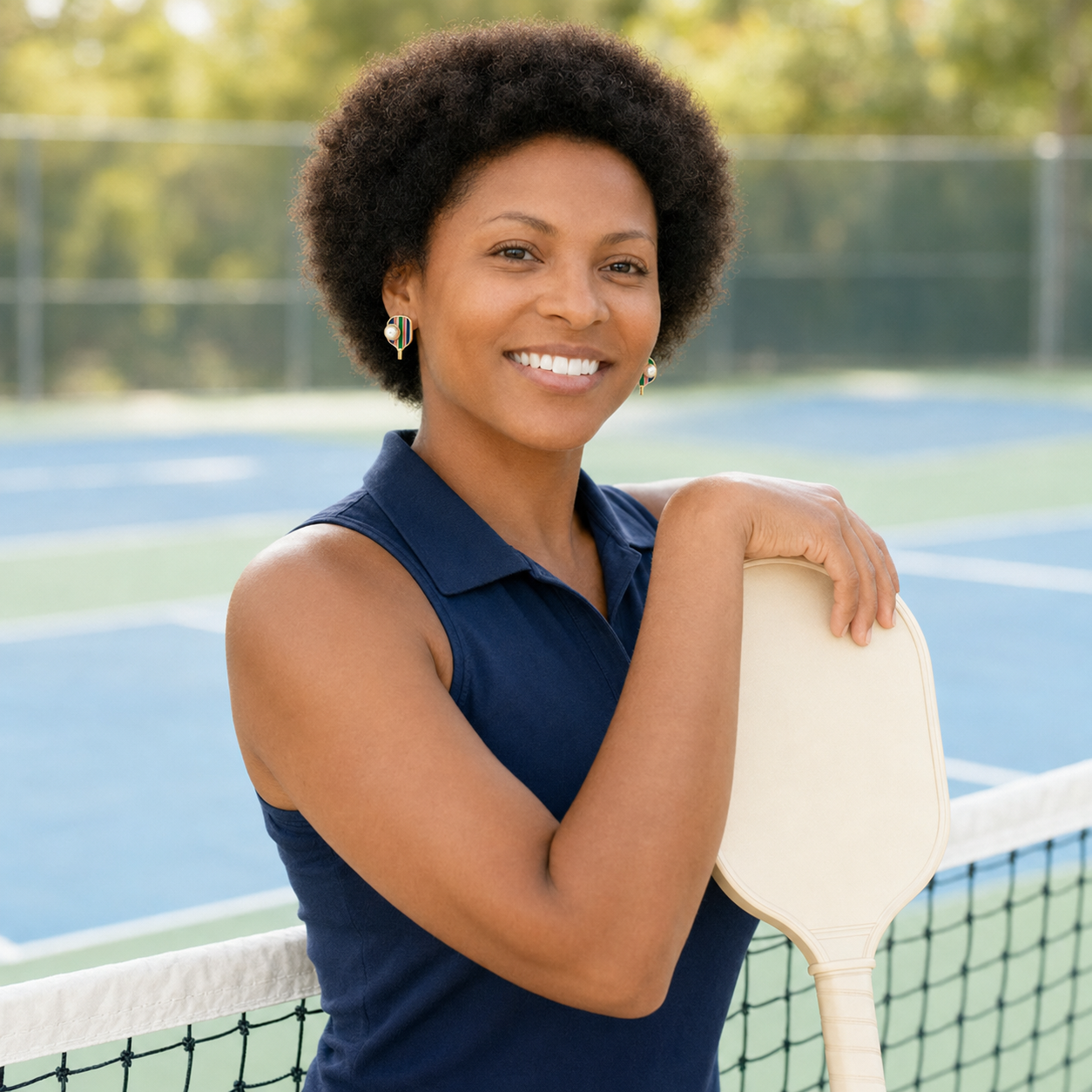 Pickleball enamel and pearl earrings styled with court gear