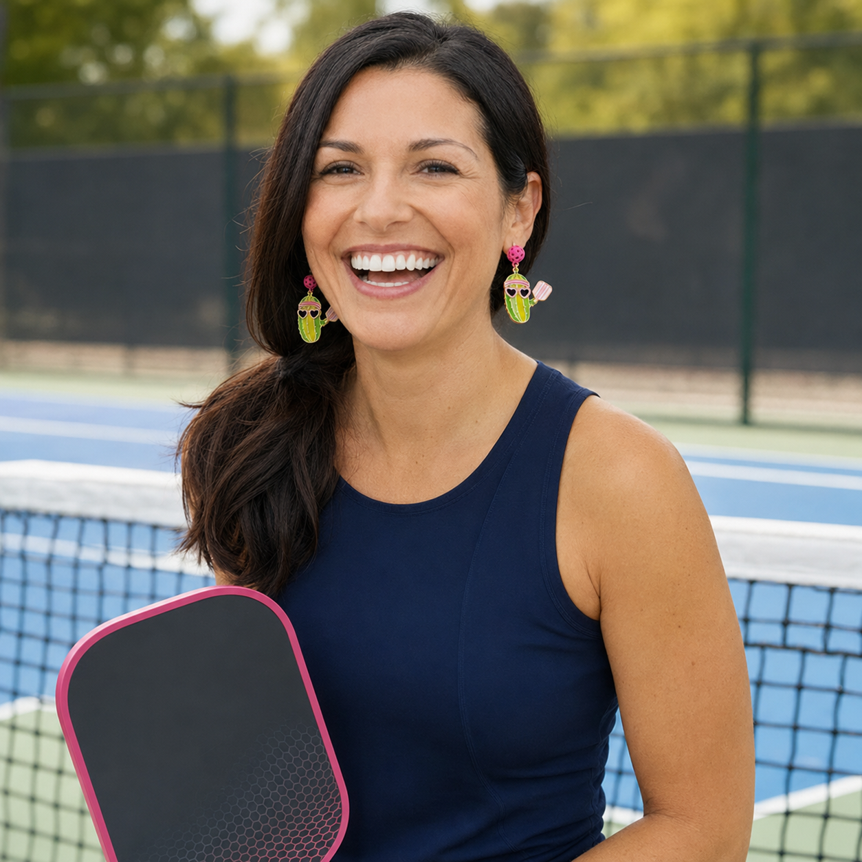 Pickle playing pickleball earrings in a jewelry box