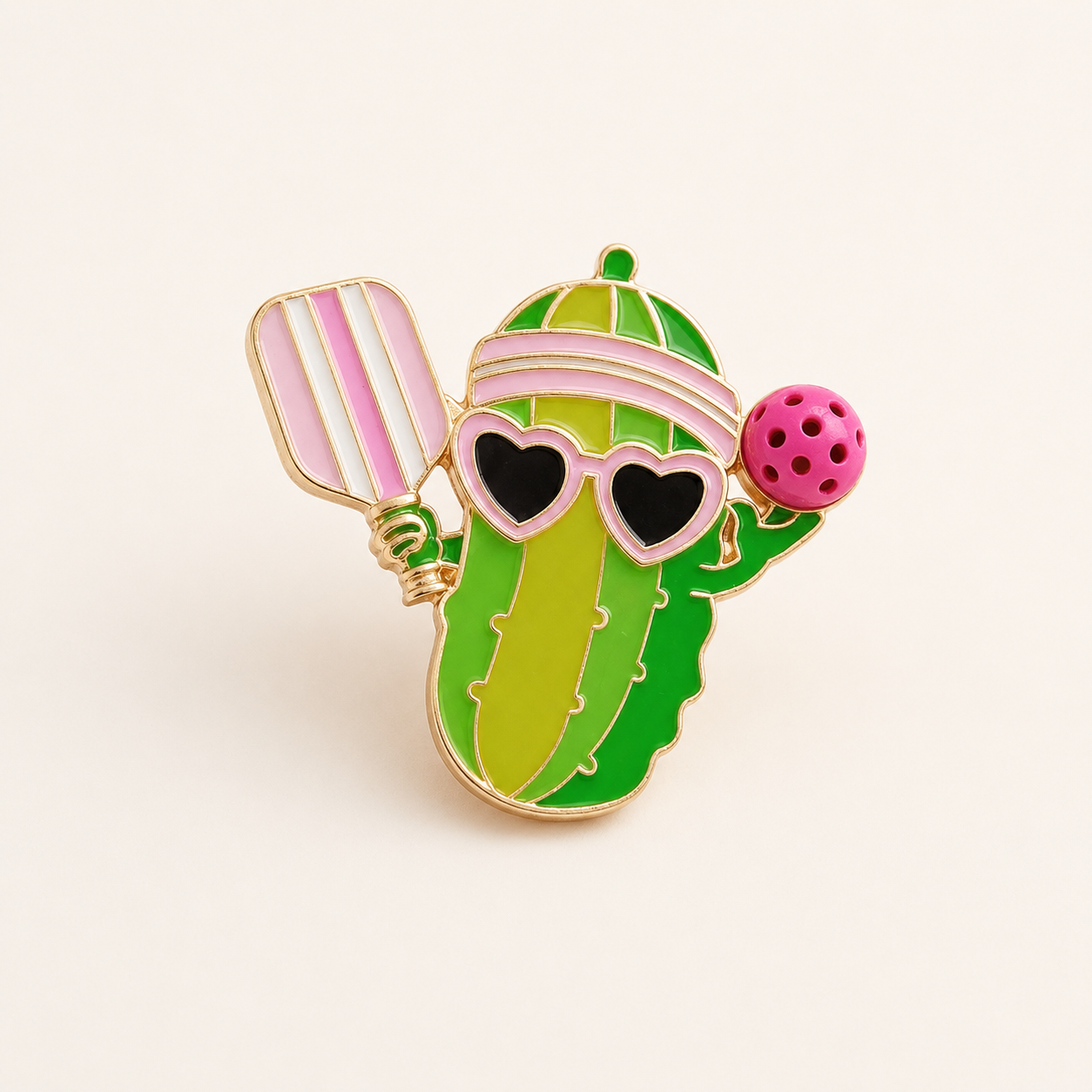 Pickleball pickle paddle and ball brooch pin on a white background