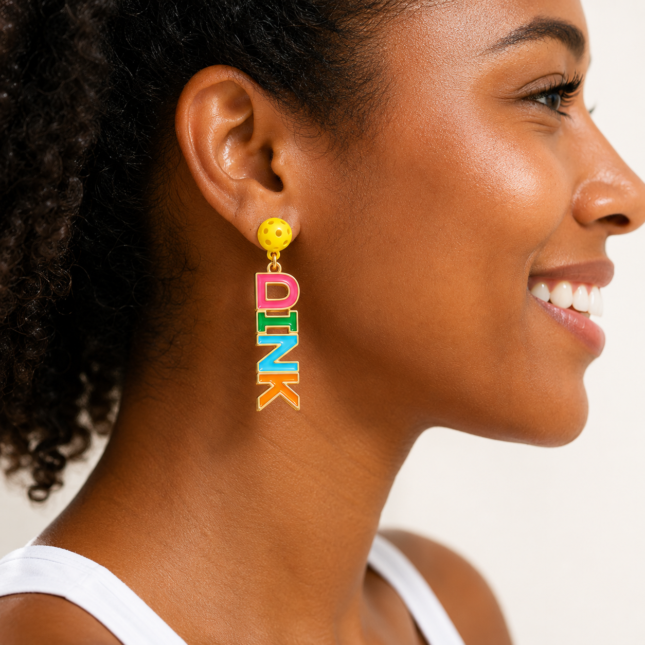 Side profile close-up of DINK enamel earrings