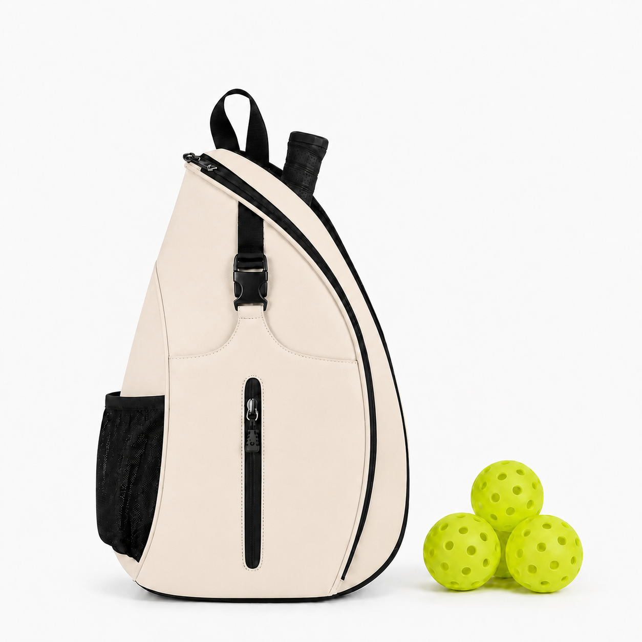 A cream-colored sling backpack with black trim, side pocket, and zipper, shown next to three lime green massage balls on a white background.