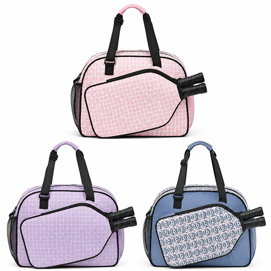 Three duffel-style bags shown on a white background: a pink bag at the top, a lavender bag at bottom left, and a blue bag at bottom right. Each bag has black handles and trim, a grid-patterned front panel, and a patterned flap detail.