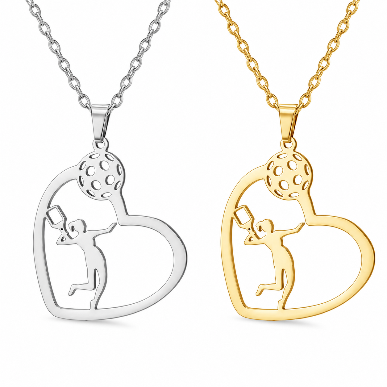 Two heart-shaped pendant necklaces on chains, one in silver and one in yellow gold, both featuring a cutout silhouette of a person holding a golf ball overhead.