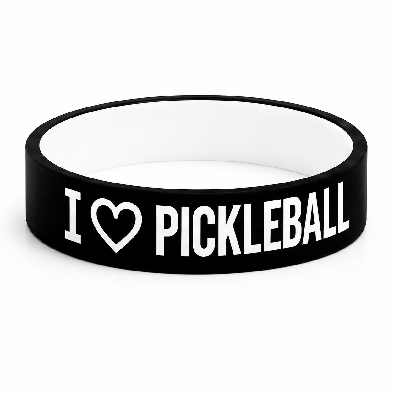 A black silicone wristband with white text reading 'I [heart] PICKLEBALL' on a clean white background.
