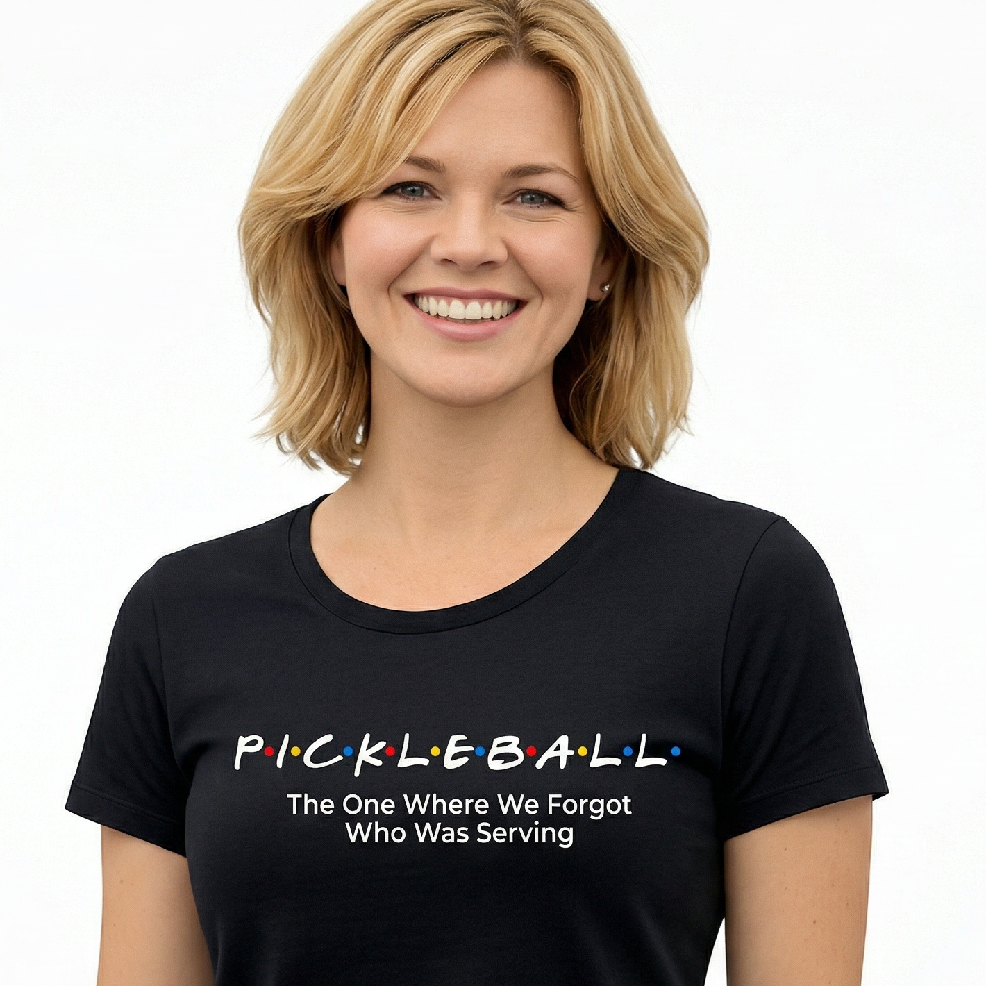 Woman wearing a black t-shirt with 'Pickleball: The One Where We Forgot Who Was Serving' text.
