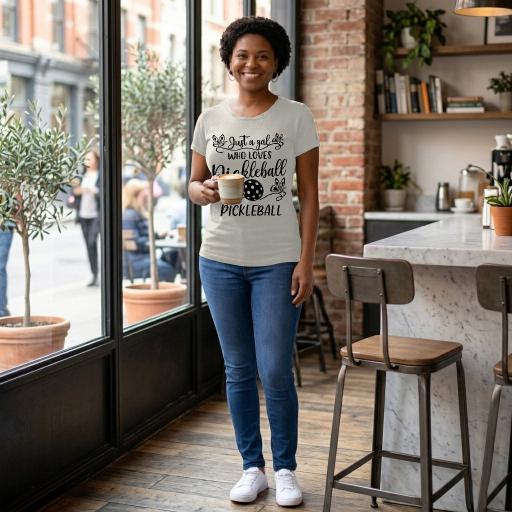 Woman wearing a t-shirt with pickleball design in a cafe setting
