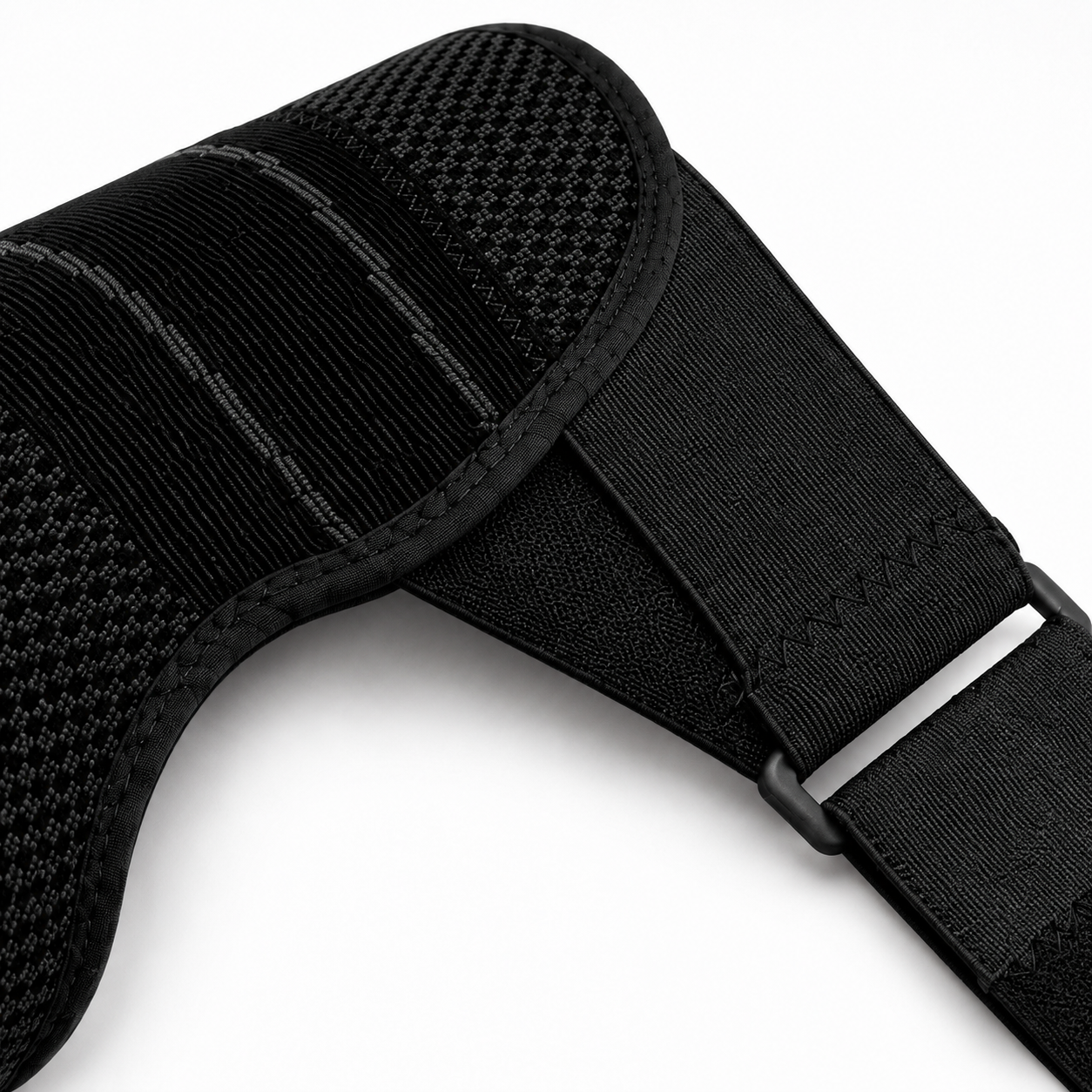 Close-up of the black shoulder brace breathable knit, reinforced stitching, adjustable strap, and guide loop