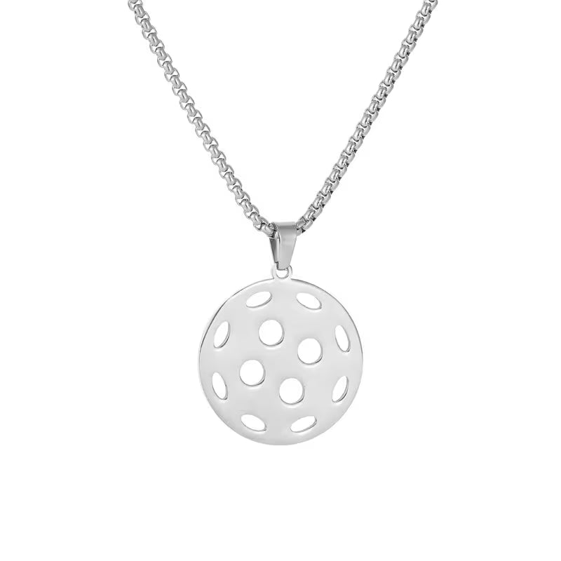 A silver pendant necklace featuring a circular disc pendant with a series of cutout circles, suspended from a classic box chain against a plain white background.