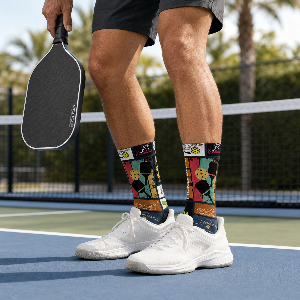 Man wearing colorful Frame Worthy pickleball socks on an outdoor pickleball court