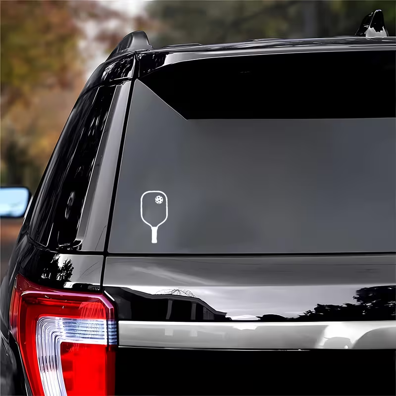 White pickleball paddle decal on black SUV rear window