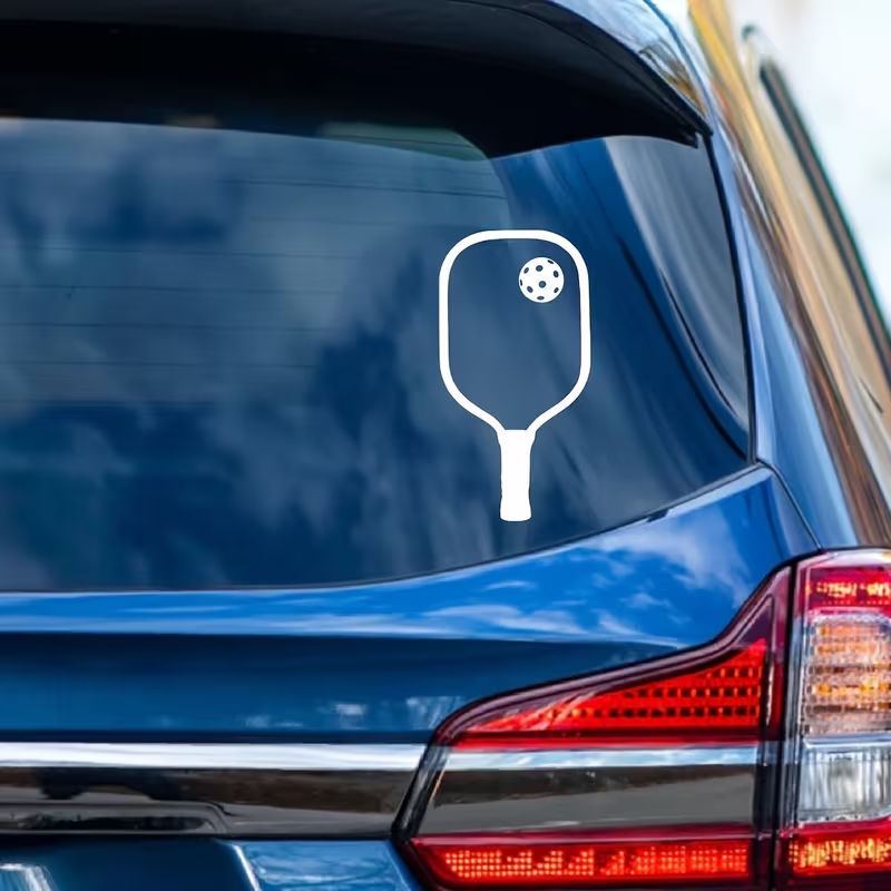 White pickleball paddle decal on blue SUV rear window