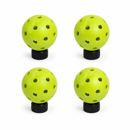 Four green pickleball tire valve caps for Schrader valves on a white background