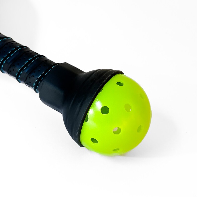 Pickleball paddle fitted with ball-retriever attachment